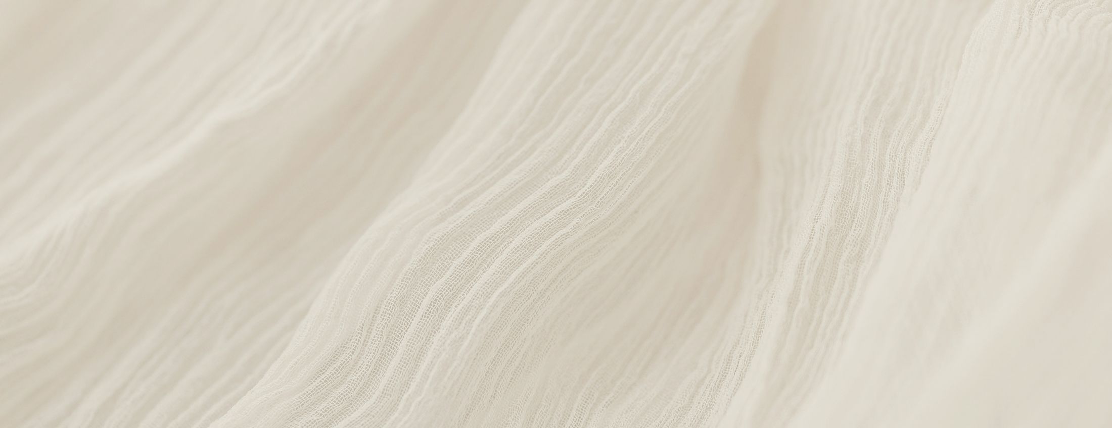 Soft, textured cream-colored fabric close-up.