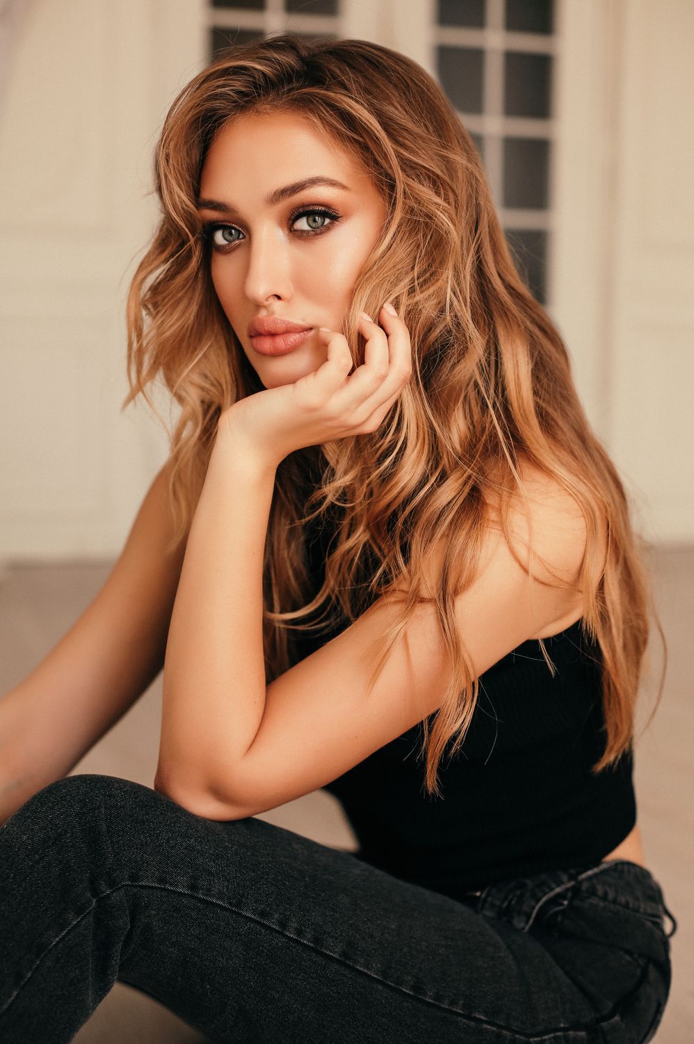 Woman in activewear near a window.
